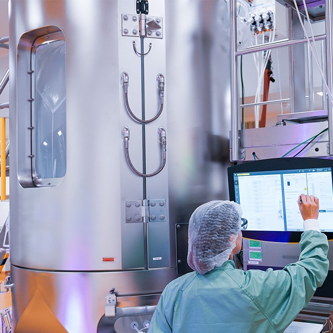 A laboratory technician programming a machine.